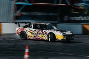 Dynamic shot of a racing car drifting on a track during daylight in Istanbul, Turkey.
