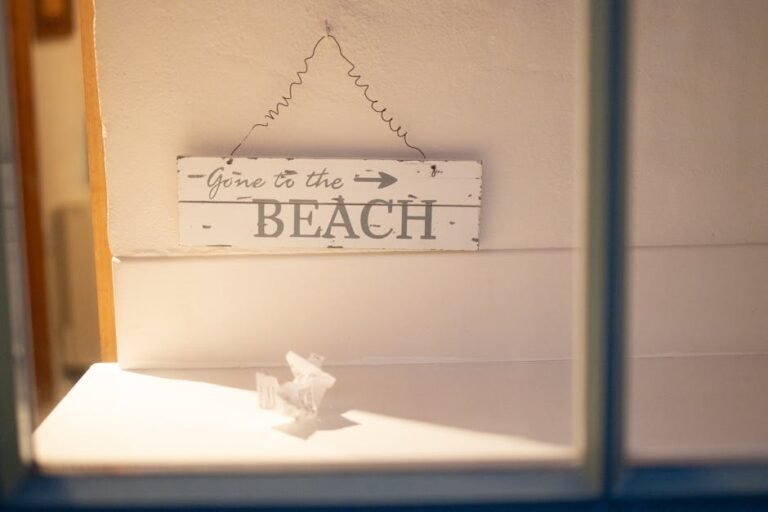 Wooden sign reading 'Gone to the Beach' hangs inside with soft lighting.
