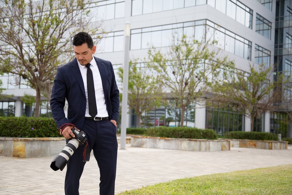 Business photographer with camera in formal attire at Daytona Beach office building.