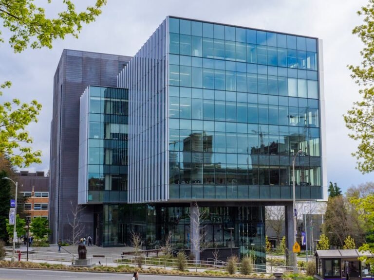 Stunning modern glass building exterior with urban reflections.