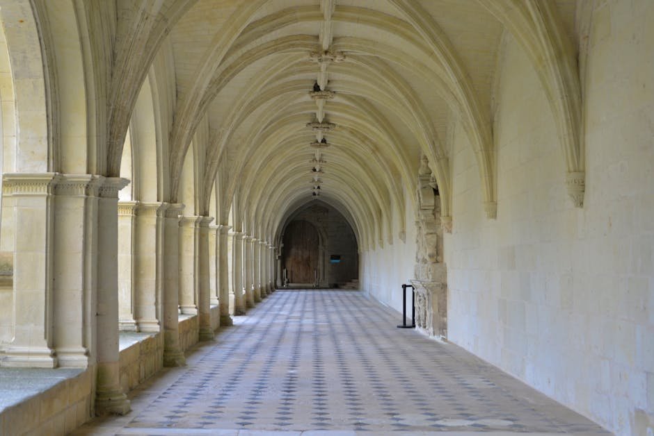A serene view of the cloister arches in Fontevraud Abbey, France.