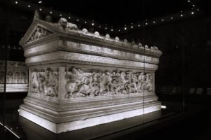 Intricately carved sarcophagus in a dark museum in İstanbul.